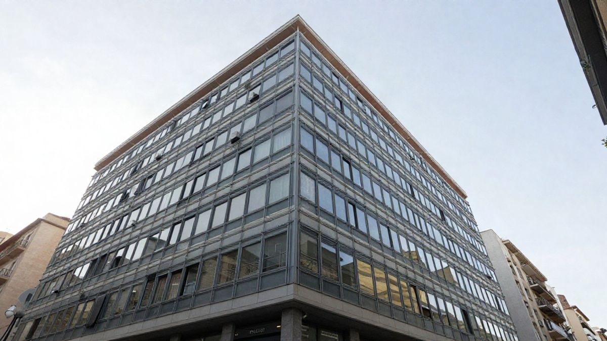 Imagen ilustrativa: ángulo bajo de un edificio moderno de oficinas con cielo de fondo
