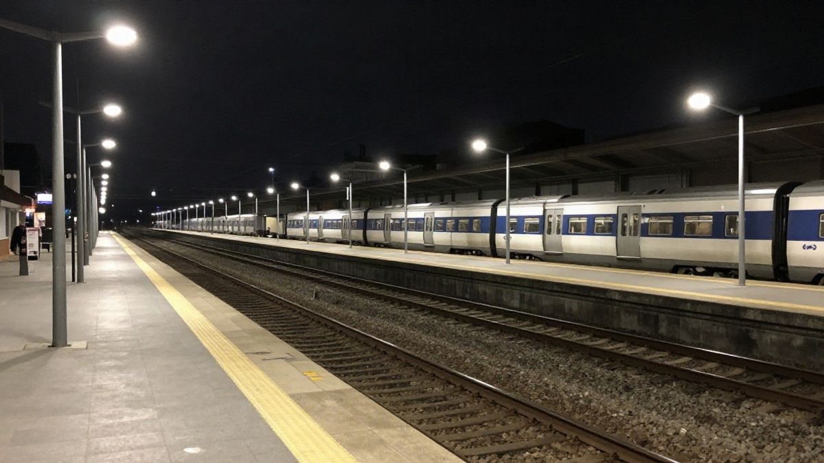 Illustrative image: railway station platform at night with artificial light and empty tracks
