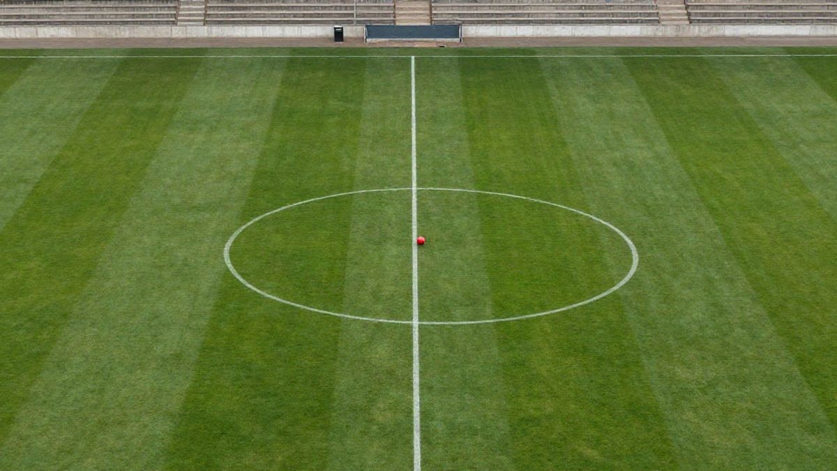 Illustrative image: aerial view of a football pitch with a ball next to the penalty spot