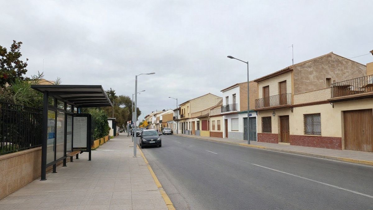 Illustrative image: a bus stop on a typical residential street, with a cloudy sky in the background